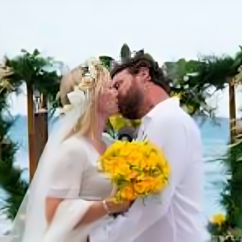 Lawrence Faulborn and Kelli Giddish kissing on their wedding.